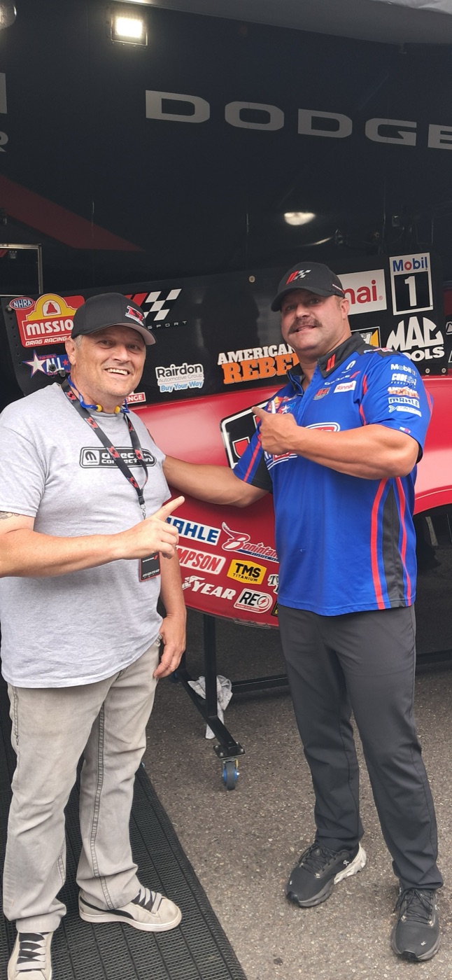 JOEY, our first Presentator and our current COO, with Matt Hagan in front of the Direct Connection Dodge trailer at Pacific Raceways in 2025.