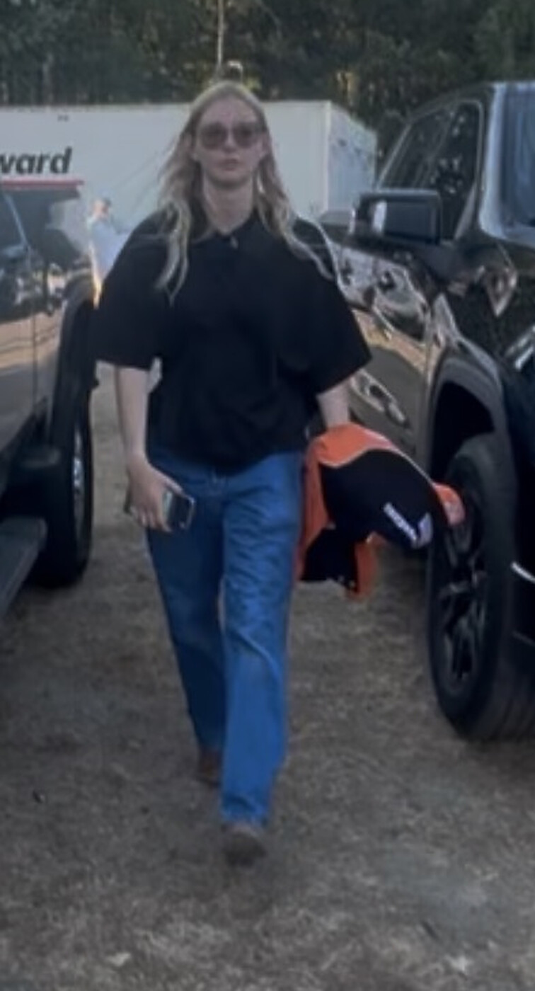 Stasia Smith, the lead JOEY racecar driver and event coordinator for the race weekend, holding her original Tony Stewart Racing jacket, signed by Tony Stewart, at Pacific Raceways in 2026.