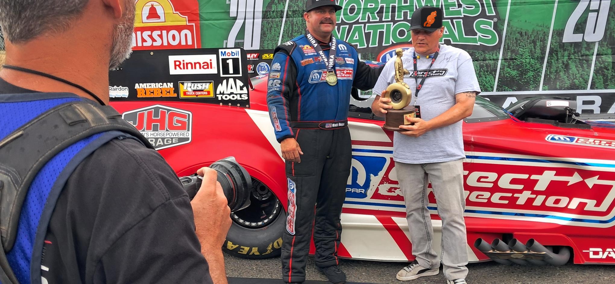 The JOEY team trackside at the NHRA Northwest Nationals with Funny Car champion Matt Hagan and the Direct Connection crew, a JOEY cap on the team